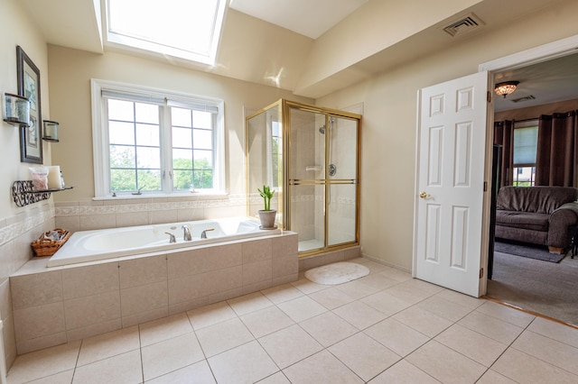 49 Central Dr, Easton, PA 18045 - ensuite bathroom with tile patterned floors, a bath, a shower stall, and a skylight