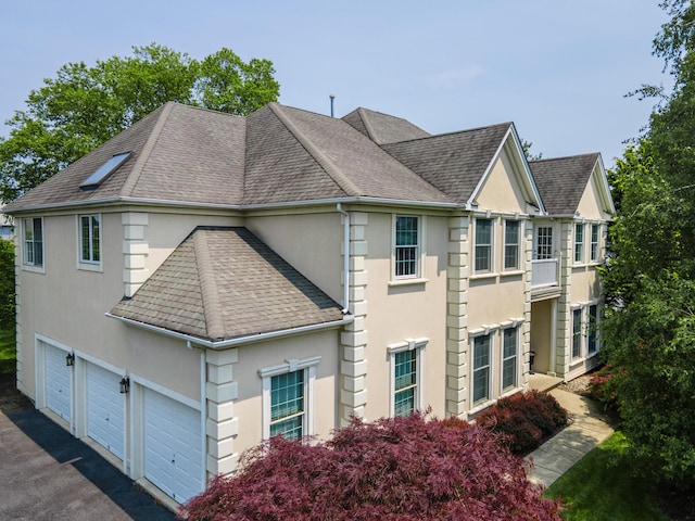 49 Central Dr, Easton, PA 18045 - view of side of property featuring stucco siding, a shingled roof, and a garage