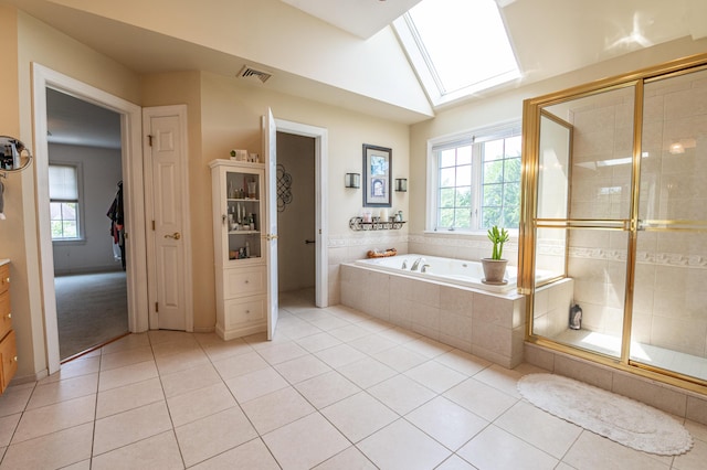 49 Central Dr, Easton, PA 18045 - full bathroom with a garden tub, tile patterned floors, a skylight, vaulted ceiling, and a stall shower