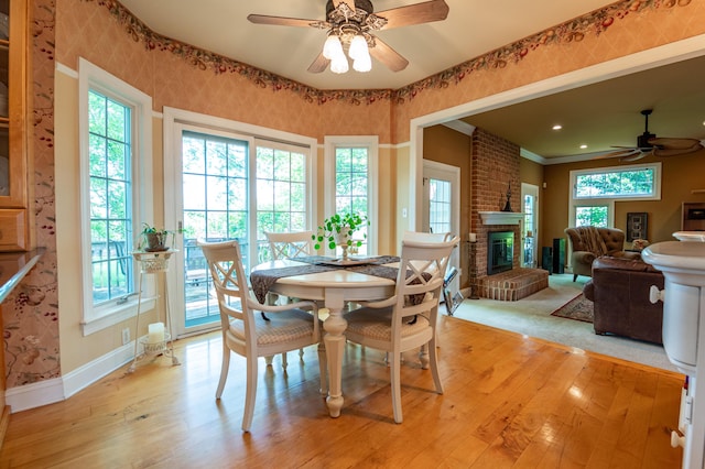 49 Central Dr, Easton, PA 18045 - dining area featuring a ceiling fan, a fireplace, light wood-type flooring, plenty of natural light, and wallpapered walls
