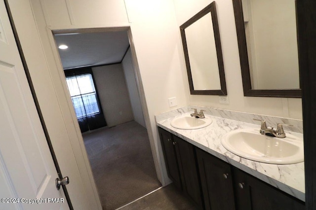 bathroom with a sink and double vanity