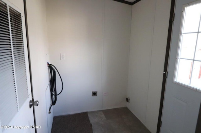 laundry room featuring a healthy amount of sunlight, laundry area, a heating unit, and hookup for an electric dryer