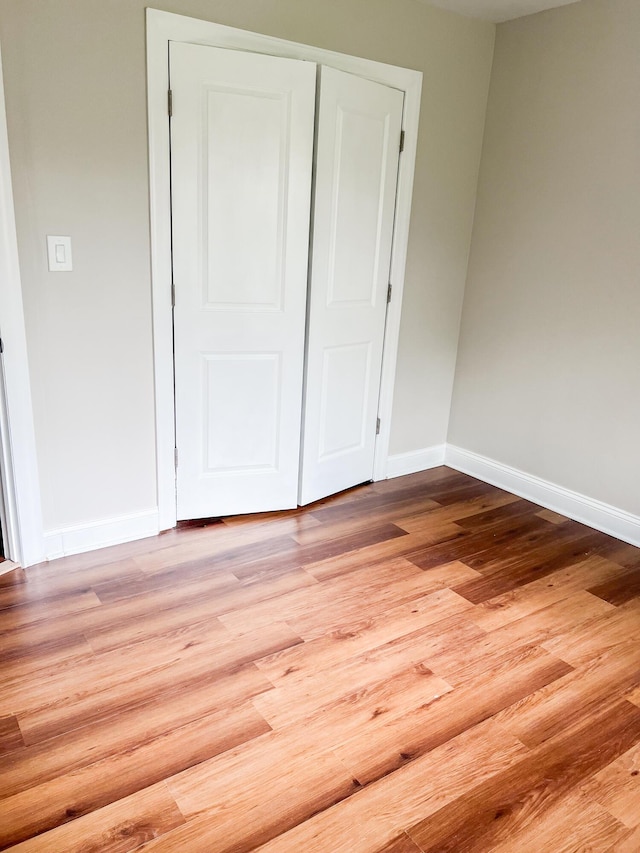 319 Whipporwill Dr, Bushkill, PA 18324 - unfurnished bedroom featuring baseboards, light wood-style flooring, and a closet