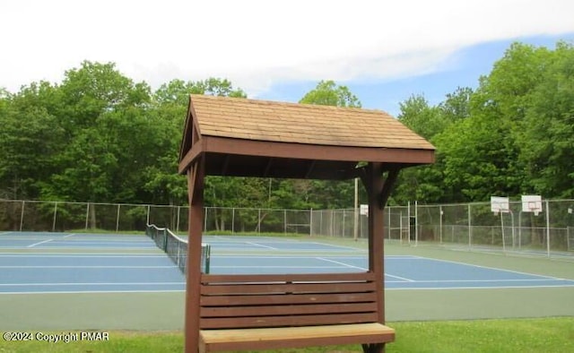 view of sport court featuring fence