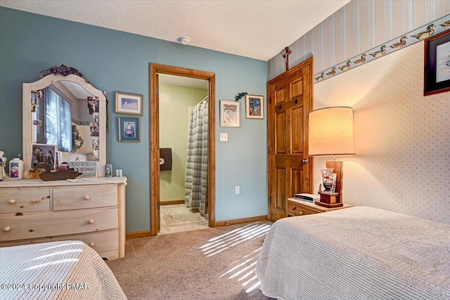 bedroom featuring wallpapered walls, baseboards, and light colored carpet