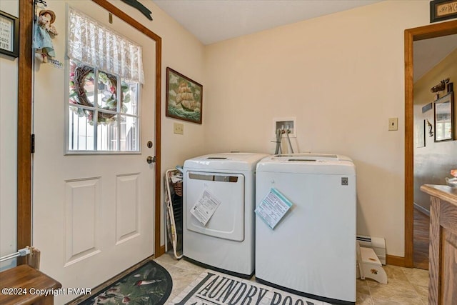 washroom featuring washer and dryer, laundry area, baseboards, and light tile patterned floors