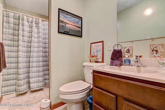 bathroom featuring toilet, a shower with shower curtain, and vanity