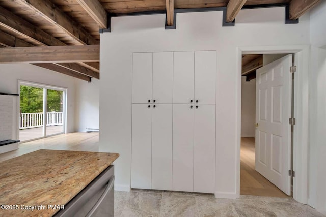 kitchen with lofted ceiling with beams, white cabinetry, a baseboard heating unit, and wood ceiling