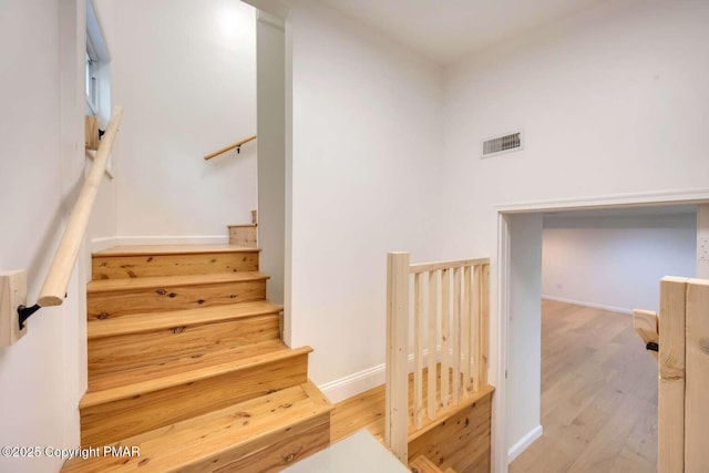 stairs with hardwood / wood-style floors