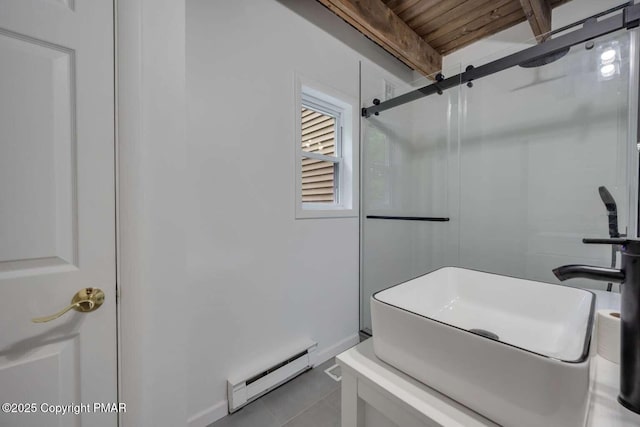 bathroom with a shower with door, a baseboard heating unit, and tile patterned floors