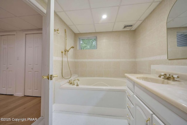 bathroom featuring a paneled ceiling, vanity, shower / bath combination, and hardwood / wood-style floors