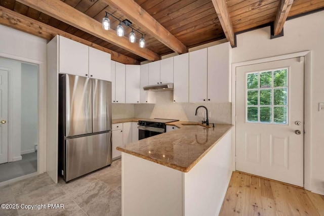 kitchen featuring black range with electric cooktop, stainless steel fridge, sink, and white cabinets