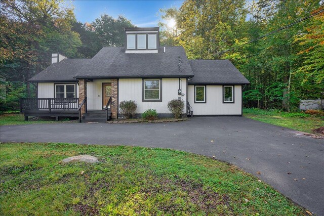 5266 Beechwood Rd, Blakeslee, PA 18610 - view of front of house with roof with shingles, a front lawn, a deck, a chimney, and driveway