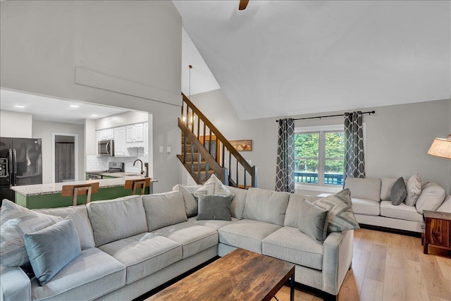 5266 Beechwood Rd, Blakeslee, PA 18610 - living room featuring recessed lighting, light wood finished floors, high vaulted ceiling, and stairway