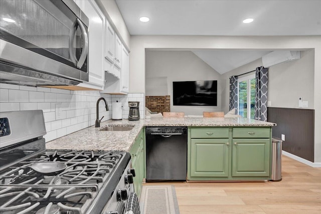 5266 Beechwood Rd, Blakeslee, PA 18610 - kitchen featuring a peninsula, light wood-type flooring, green cabinetry, a sink, and stainless steel appliances