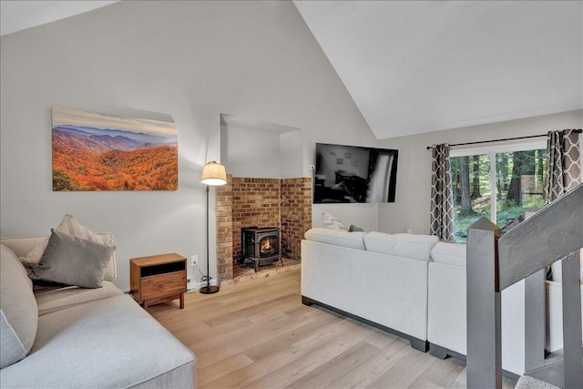 5266 Beechwood Rd, Blakeslee, PA 18610 - living room with light wood-style floors, high vaulted ceiling, and a wood stove