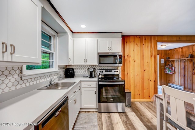 kitchen featuring white cabinetry, sink, tasteful backsplash, and stainless steel appliances