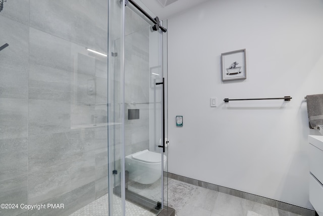 bathroom with baseboards, a shower stall, and toilet