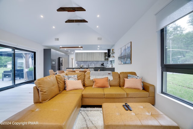 living area with high vaulted ceiling, wood finished floors, visible vents, and recessed lighting