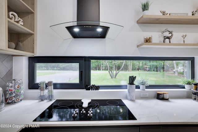 kitchen with extractor fan, black electric cooktop, open shelves, and a wealth of natural light