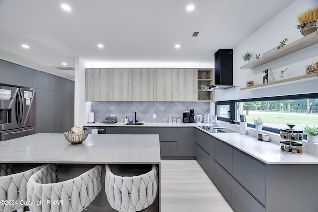 kitchen featuring modern cabinets, light countertops, ventilation hood, gray cabinetry, and open shelves