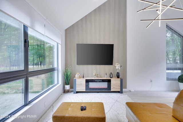 living room with vaulted ceiling, a healthy amount of sunlight, and a fireplace