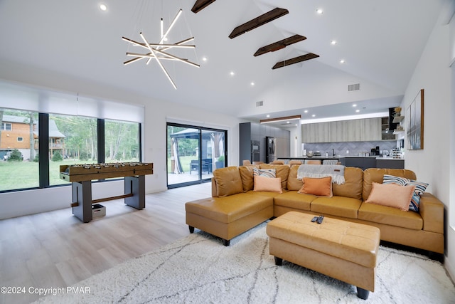 living room with light wood finished floors, visible vents, an inviting chandelier, high vaulted ceiling, and recessed lighting