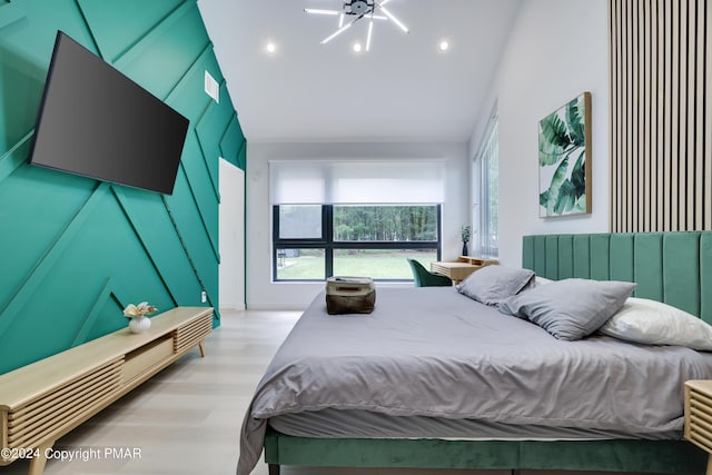 bedroom with high vaulted ceiling, wood finished floors, and recessed lighting