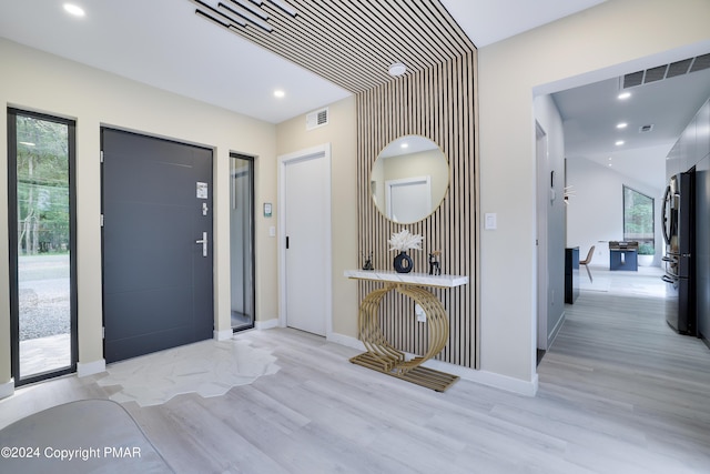 entryway with recessed lighting, visible vents, and light wood-style flooring