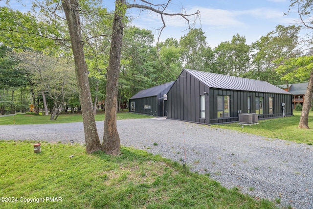 garage featuring central AC and gravel driveway