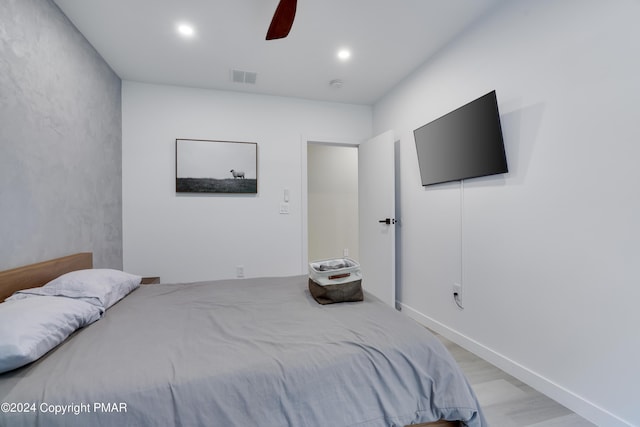 bedroom with light wood-type flooring, ceiling fan, visible vents, and recessed lighting