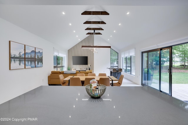 dining area featuring high vaulted ceiling, beam ceiling, a wealth of natural light, and recessed lighting