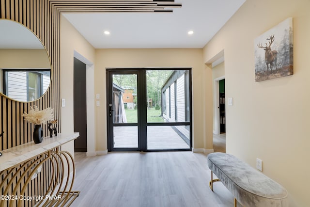 entryway with light wood-style floors, recessed lighting, and baseboards