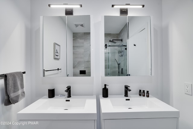 bathroom with a stall shower, vanity, and visible vents