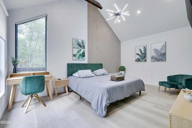 bedroom featuring high vaulted ceiling, baseboards, a notable chandelier, and light wood finished floors