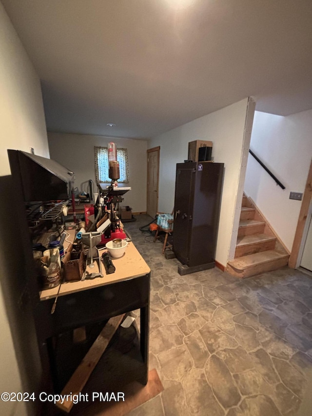 interior space featuring stairs and stone finish floor