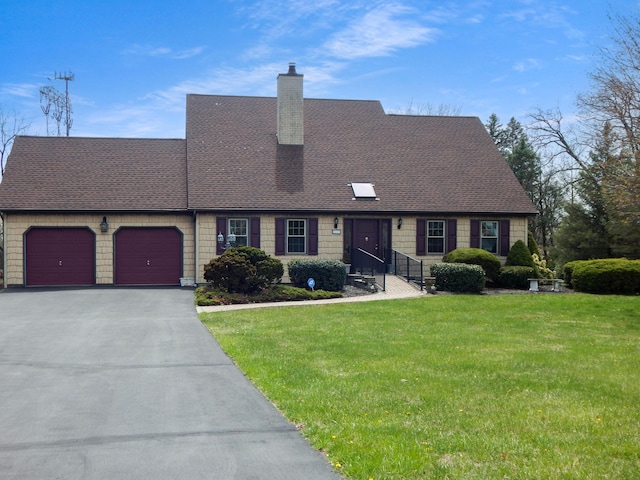 view of front facade with an attached garage, a chimney, aphalt driveway, and a front yard