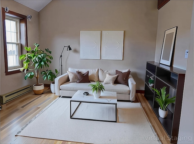 living area featuring a baseboard heating unit, wood finished floors, and vaulted ceiling