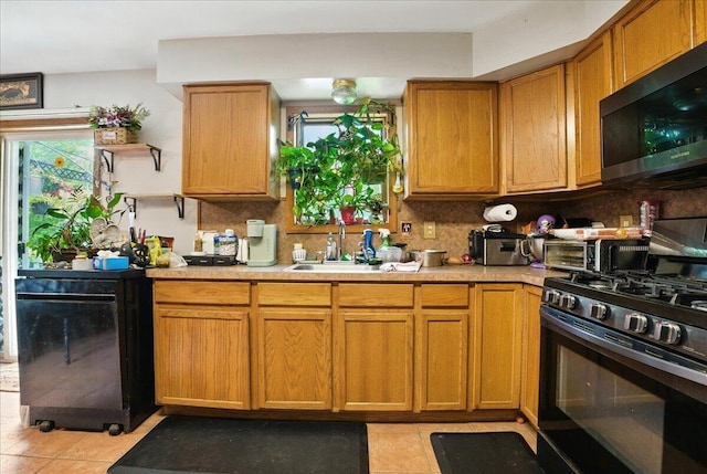2602 Pocono Forested Dr, East Stroudsburg, PA 18302 - kitchen featuring range with gas stovetop, light tile patterned flooring, decorative backsplash, and light countertops