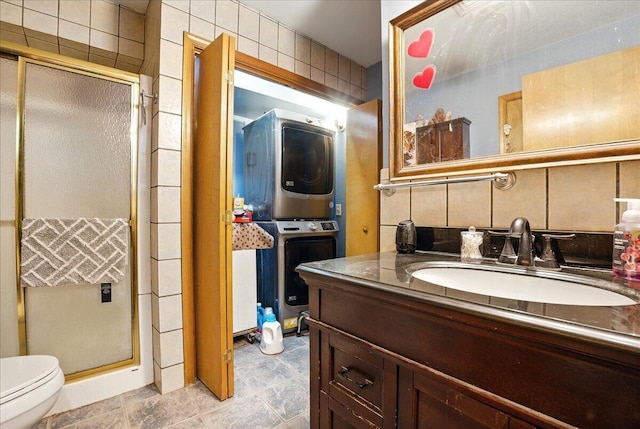 2602 Pocono Forested Dr, East Stroudsburg, PA 18302 - bathroom featuring stacked washing machine and dryer, vanity, and a stall shower