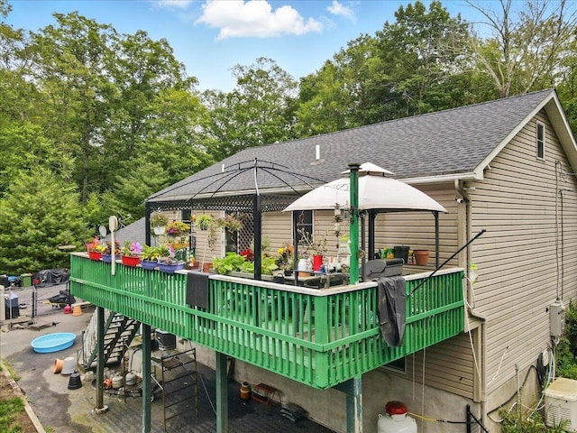 2602 Pocono Forested Dr, East Stroudsburg, PA 18302 - rear view of house with a gazebo, a shingled roof, and a wooden deck