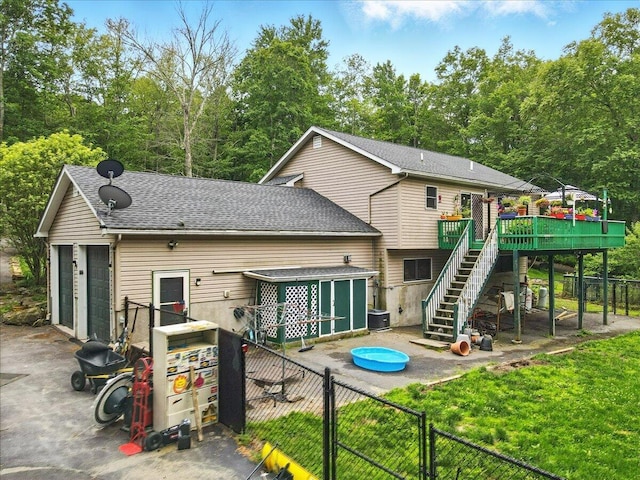 2602 Pocono Forested Dr, East Stroudsburg, PA 18302 - back of property with stairs, a fenced backyard, a wooden deck, a gate, and roof with shingles