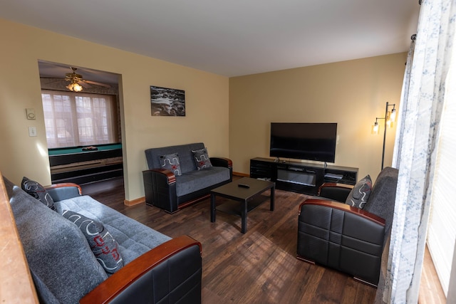 living area with wood finished floors and baseboards