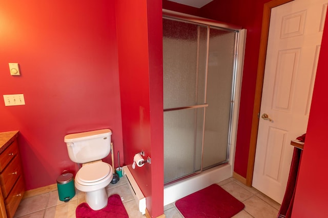 bathroom with toilet, tile patterned flooring, vanity, and a shower stall