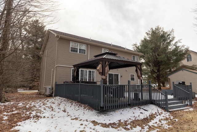 traditional home with a gazebo and a wooden deck