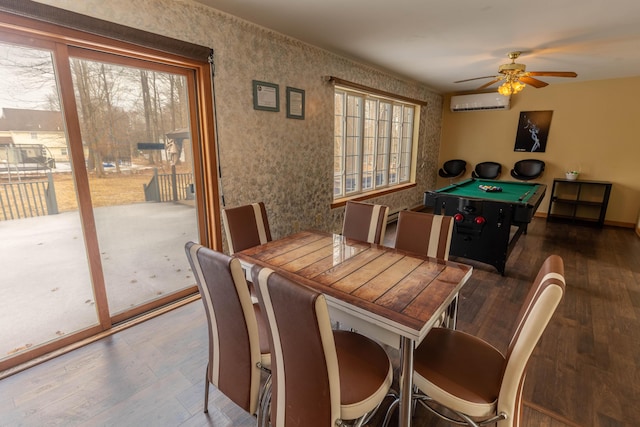 dining area with ceiling fan, pool table, a wall unit AC, and wood finished floors