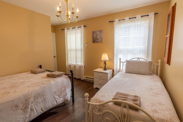 bedroom with a chandelier, multiple windows, baseboard heating, and dark wood-style flooring