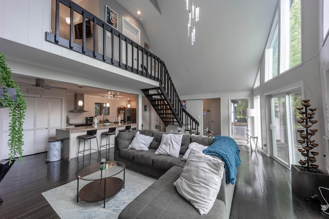living room featuring high vaulted ceiling, stairs, dark wood-style floors, a ceiling fan, and recessed lighting