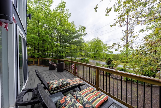 deck featuring view of wooded area
