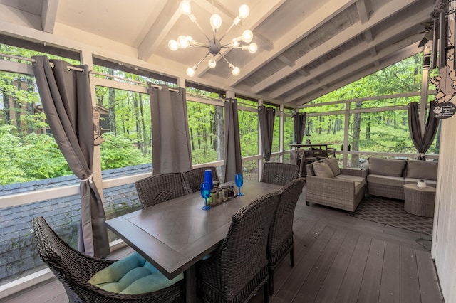 sunroom with an outdoor hangout area, outdoor dining area, and a chandelier